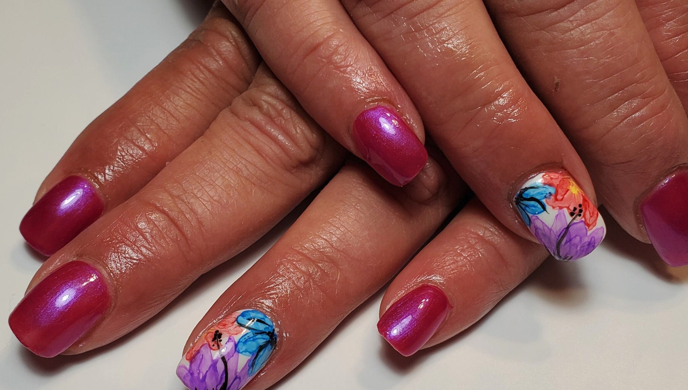 Bright floral nails at Nixi's Nails Salon in Roundup, Montana, US feature bold colors and artistic design.