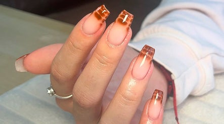 Stylish nail art at Charrpillbeauty, Harrogate, England, GB showcasing intricate brown patterns on fingernails.