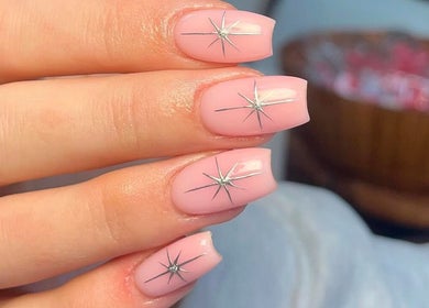 Elegant starry nail art at Charrpillbeauty, Harrogate, England, GB showcases intricate pink nail designs.