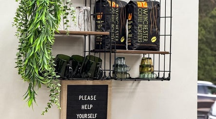Inviting coffee nook at Caylee Heath Bridal Hair, Waterlooville featuring lush greenery and Winchester coffee bags.
