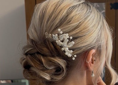 Intricate bridal hairstyle with accessories at Caylee Heath Bridal Hair, Waterlooville, England, GB.