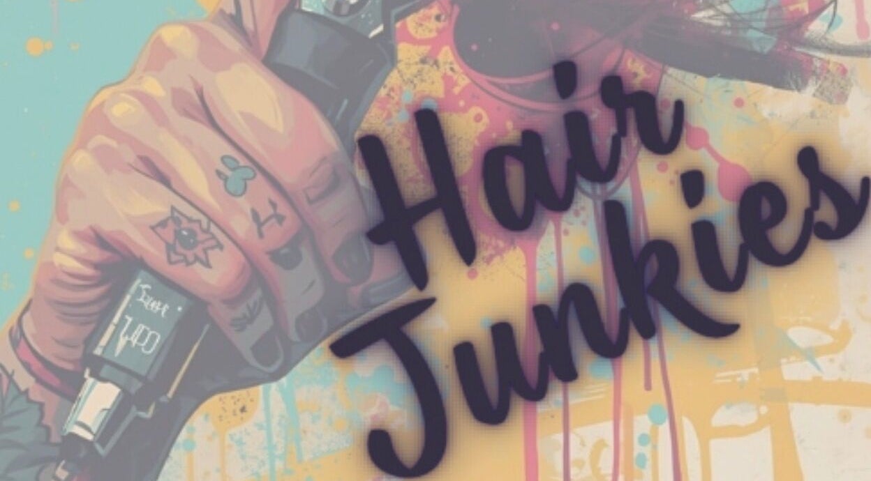 Colorful tattooed hand with clippers at Hair Junkies, Wheaton, Illinois, US, showcasing unique salon vibe.