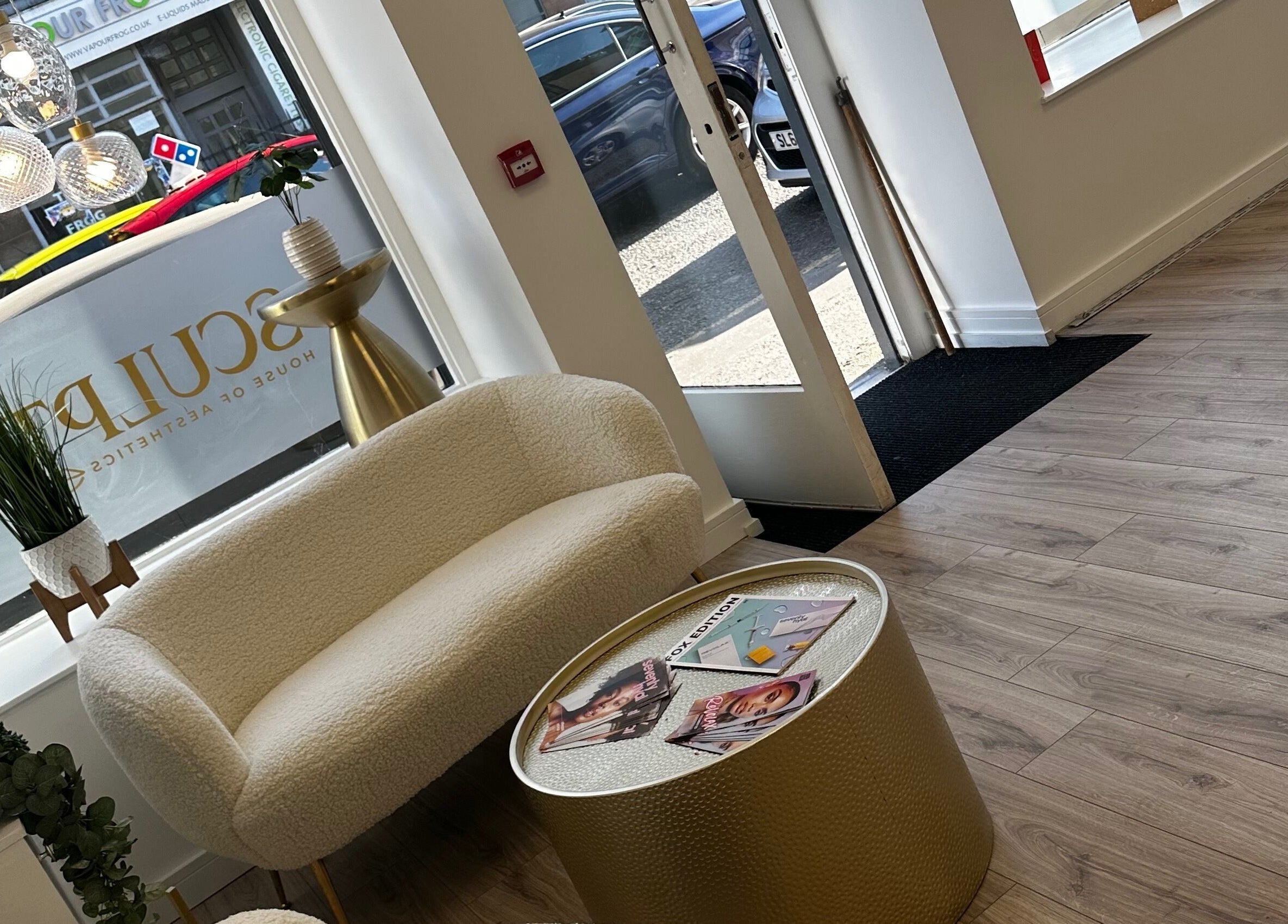 Elegant seating area at Sculpt House of Aesthetics, Johnstone, Scotland, GB with plush chair and modern decor.