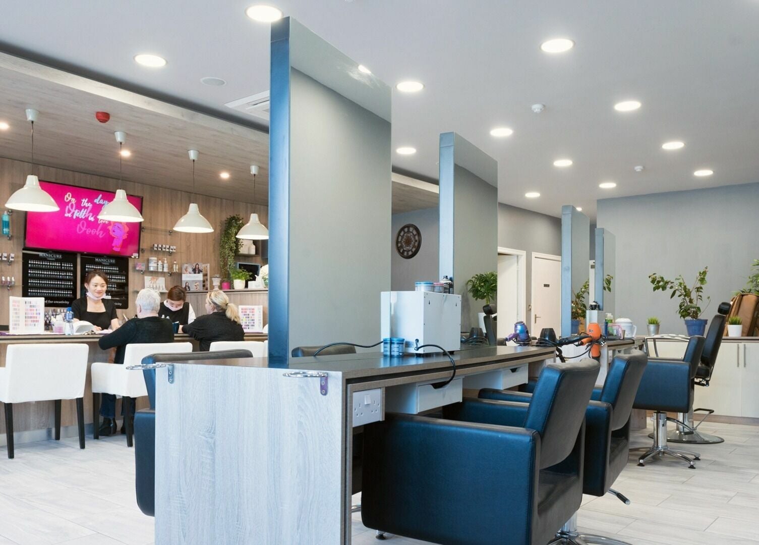 Modern interior of Salon Express Tallaght in Dublin, County Dublin, IE, featuring sleek styling stations and plush chairs.