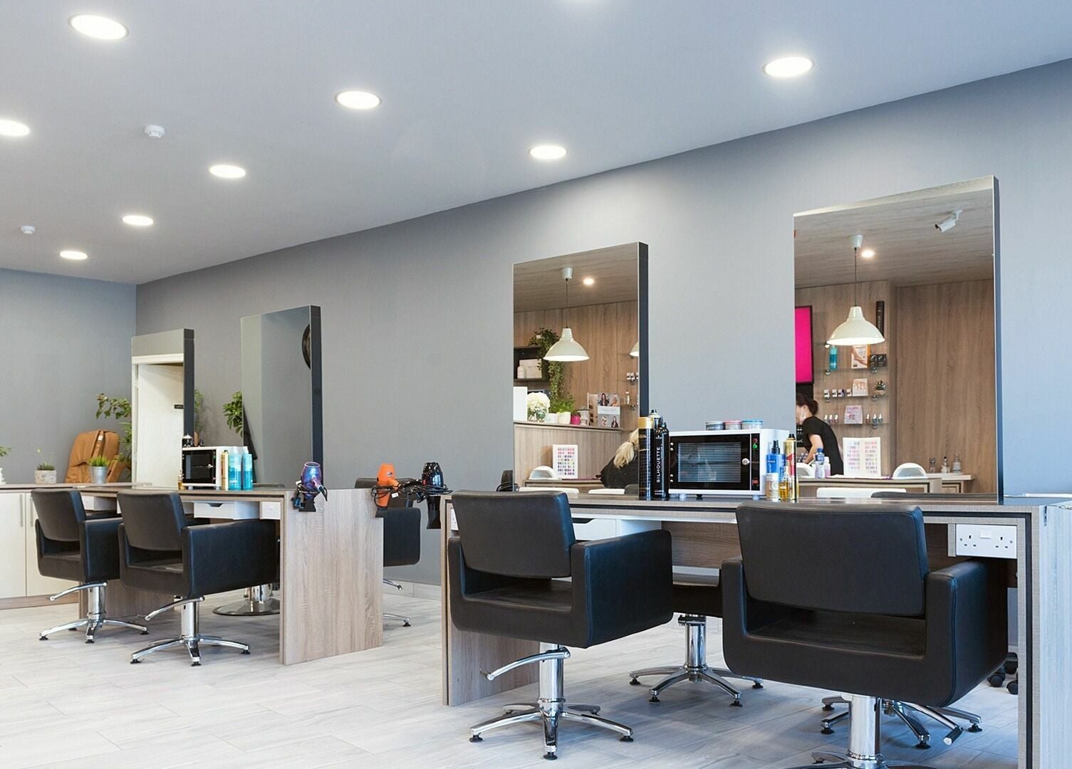 Modern salon interior at Salon Express Tallaght, Dublin, County Dublin, IE featuring sleek chairs and mirrors.