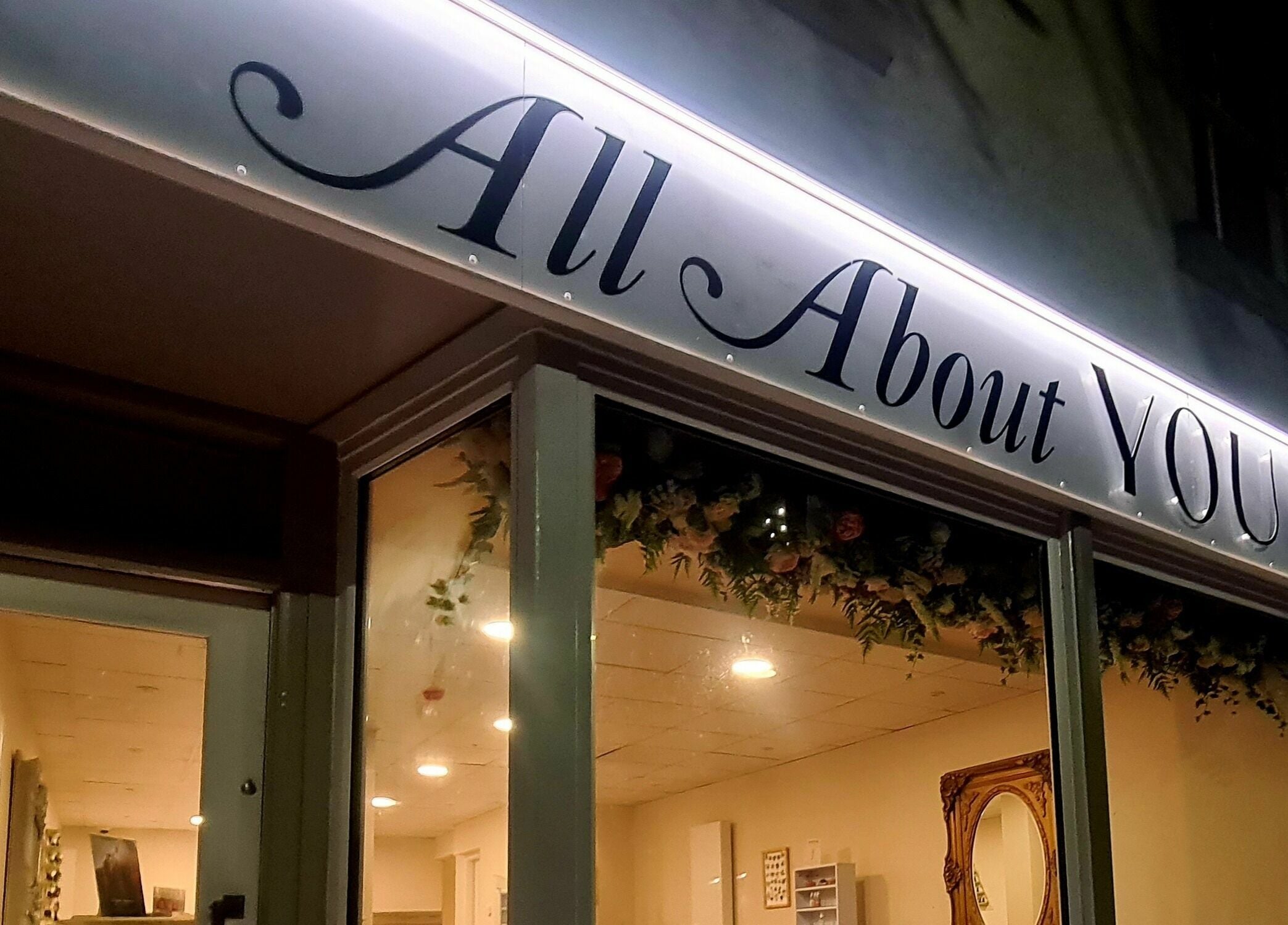 Exterior of All About You in Blairgowrie, Scotland, GB, showcasing elegant signage and warm lighting.
