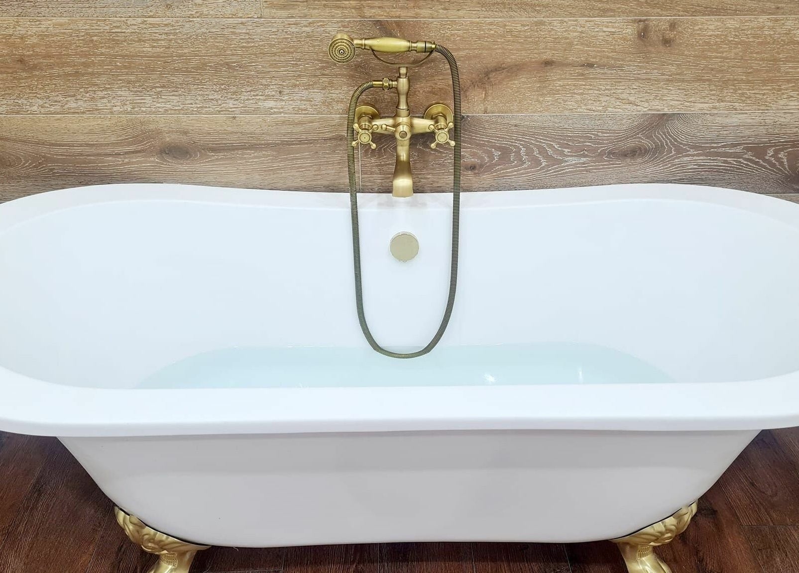 Luxurious bathtub with golden faucet at All About You, Blairgowrie, Scotland, GB.