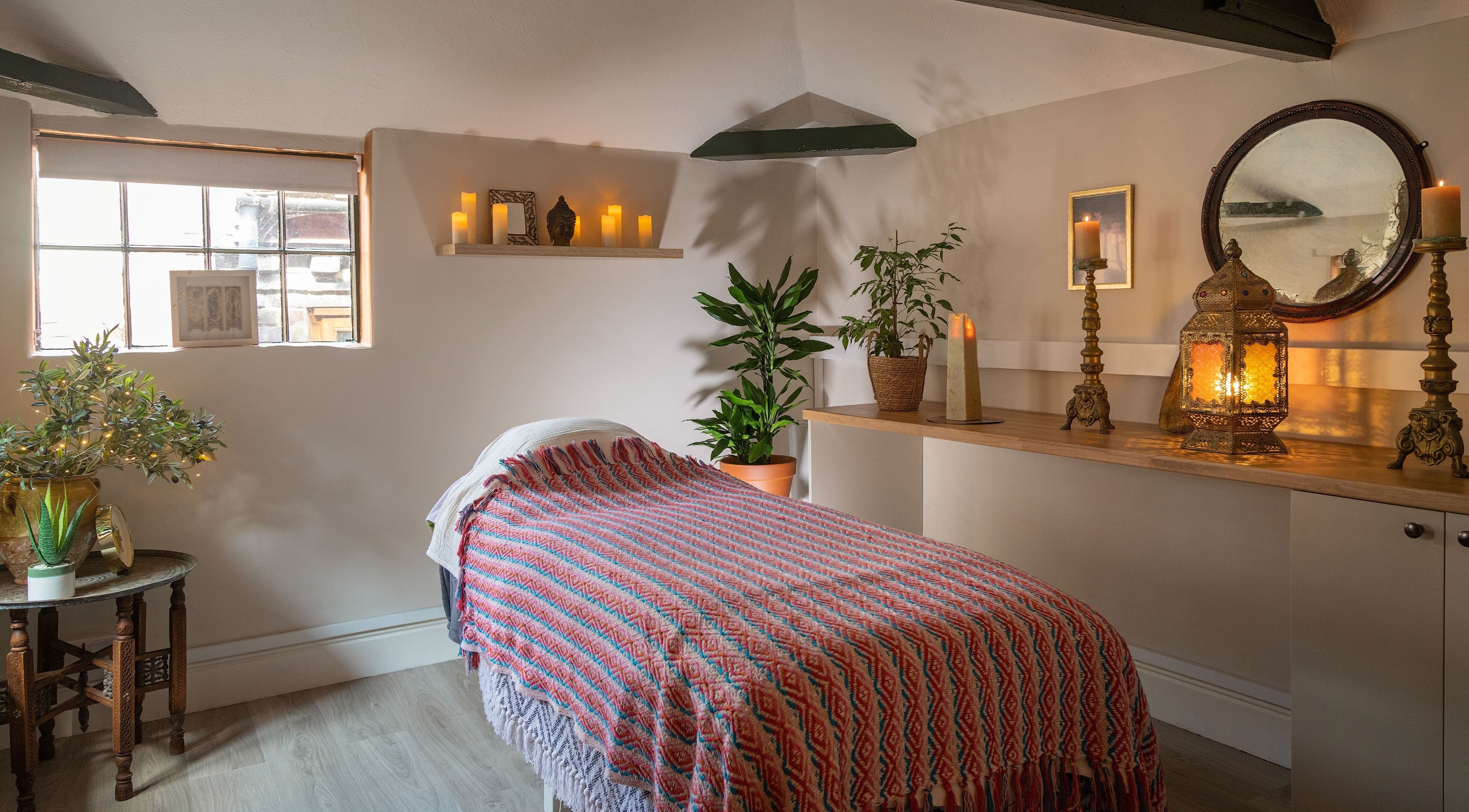 Cozy spa room at Jane Bulbeck Skincare & Beauty Ltd, Chichester, England, GB with candles and plants.