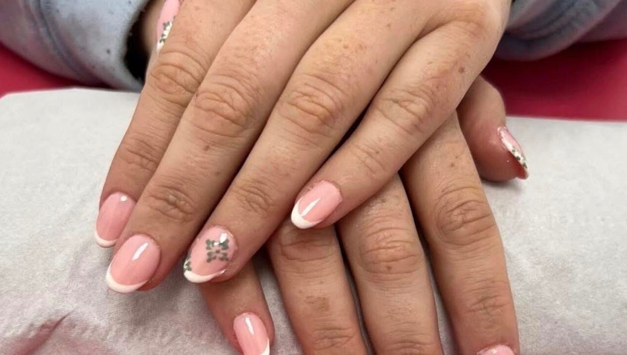 Elegant French manicure with floral detail at Beauty In The Square, Kirkintilloch, Scotland, GB.