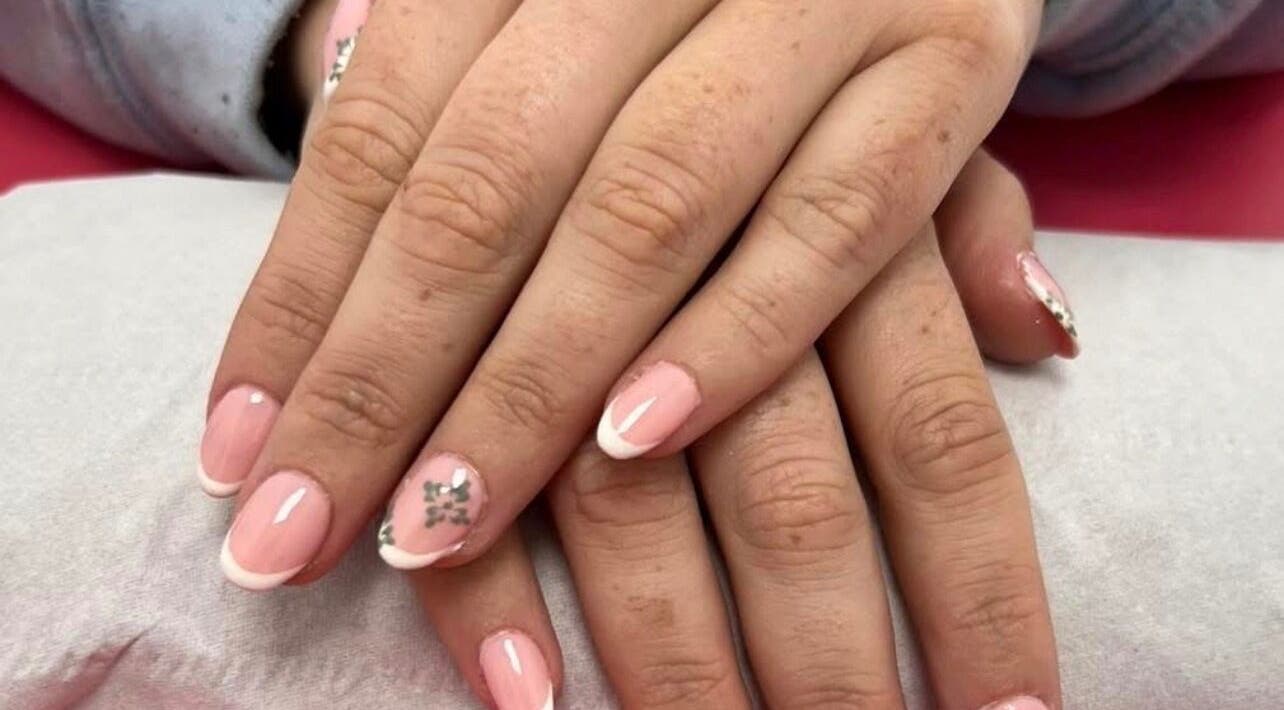 Elegant French manicure with floral detail at Beauty In The Square, Kirkintilloch, Scotland, GB.
