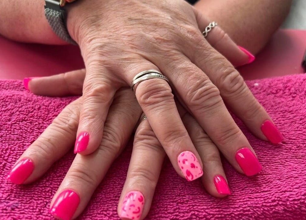Bright pink manicured nails at Beauty In The Square, Kirkintilloch, Scotland, GB.