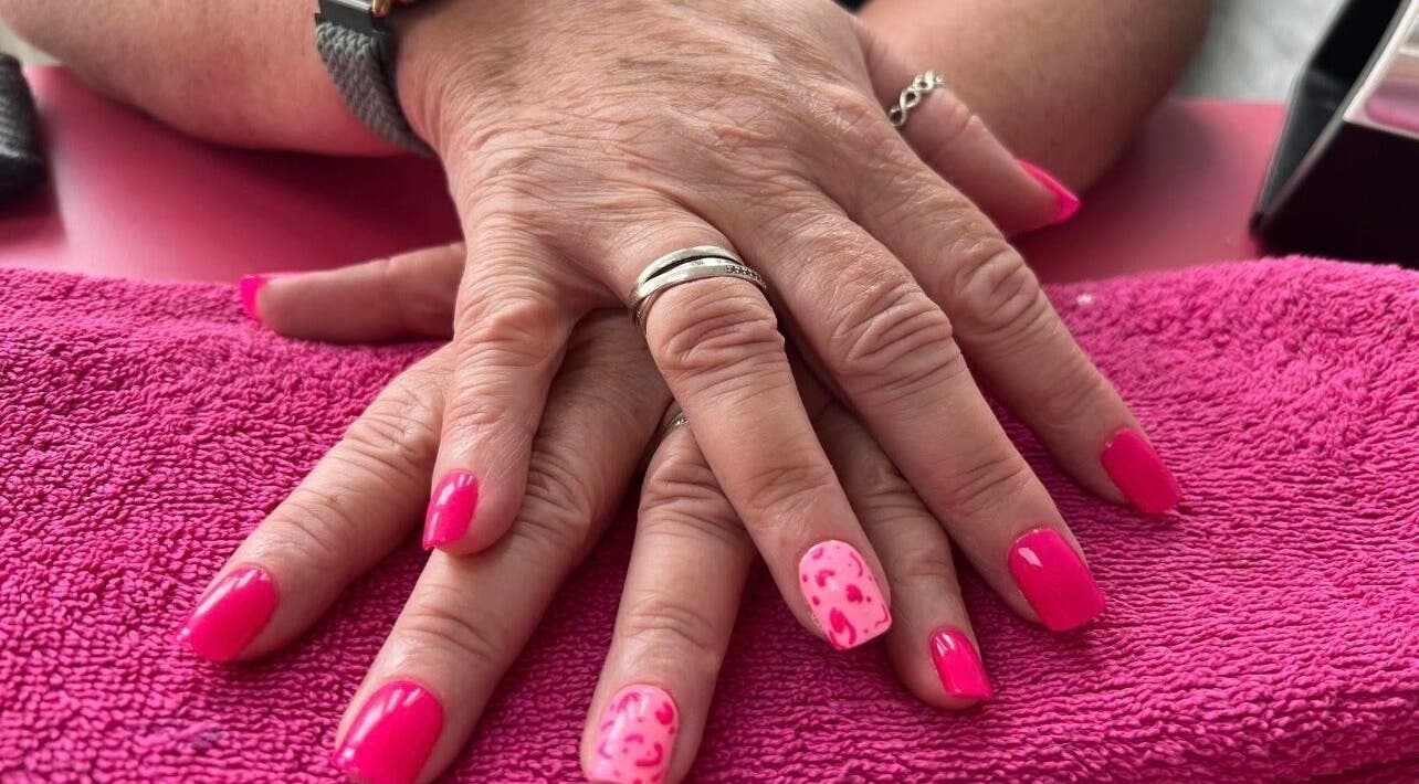 Bright pink manicured nails at Beauty In The Square, Kirkintilloch, Scotland, GB.