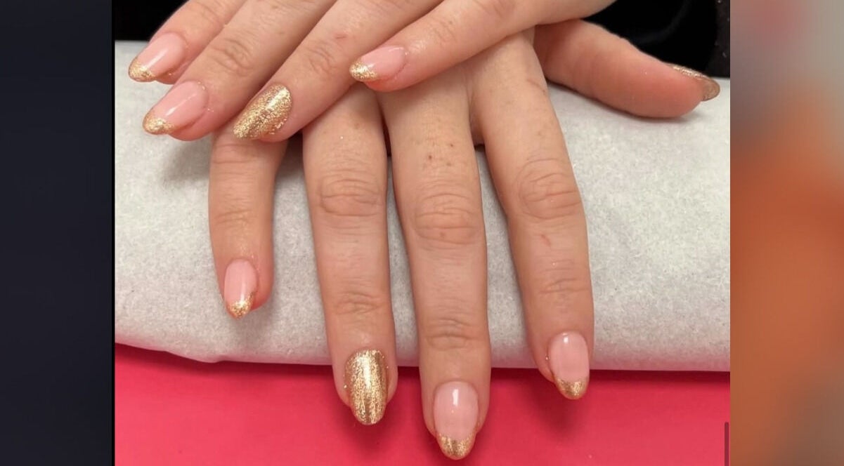 Manicured hands with gold accents at Beauty In The Square, Kirkintilloch, Scotland, GB.