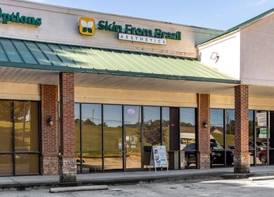 Exterior of Skin From Brazil, Stockbridge, Georgia, US with glass storefront and green awning.