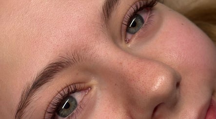 Close-up of a woman's radiant face at Aleighas Beauty, Guildford, England, GB.