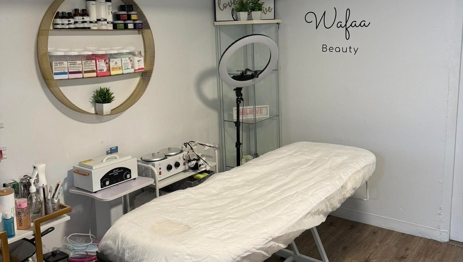 Beauty treatment room at Wafaabeaty in New York, New York, US, featuring a neatly arranged bed and skincare products.