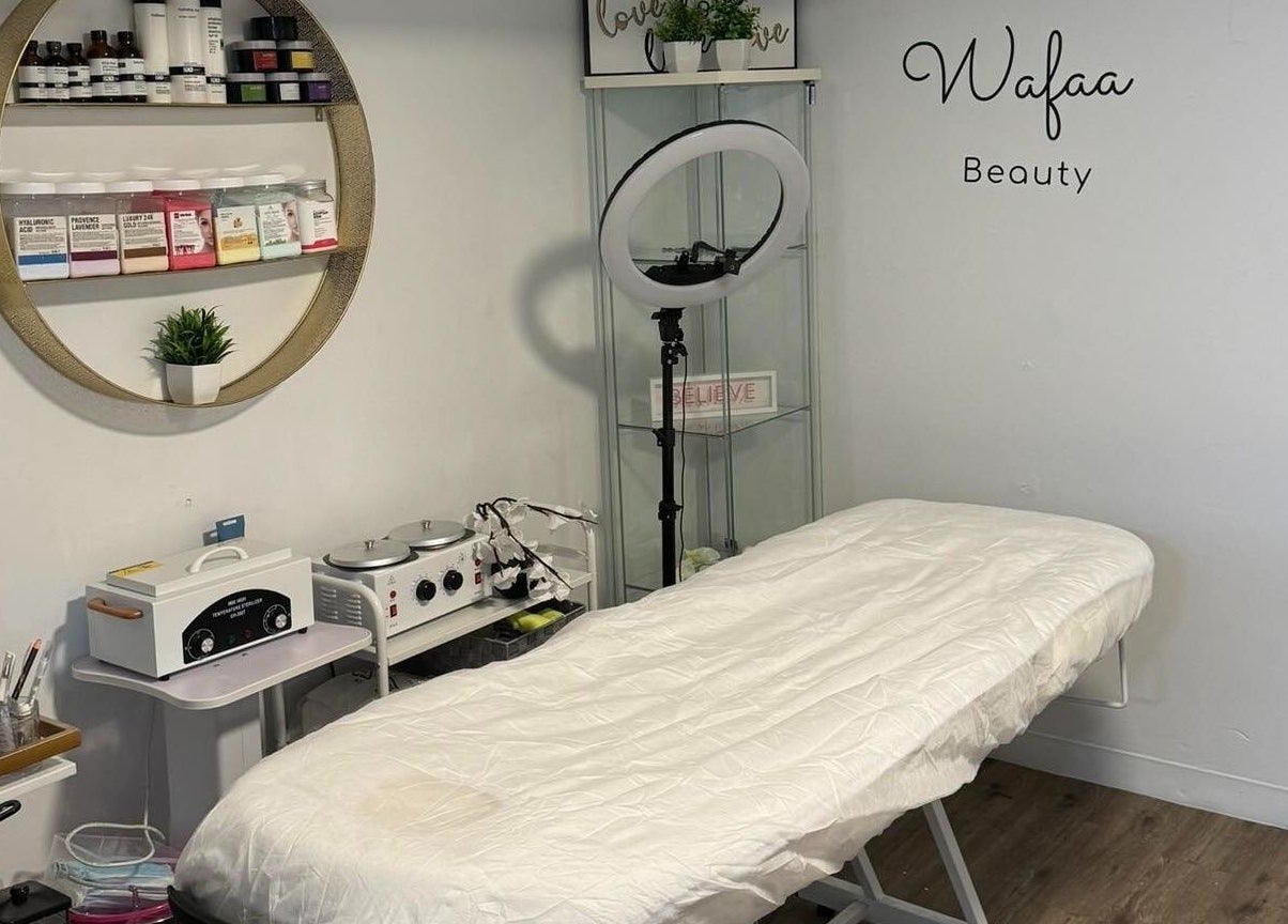 Beauty treatment room at Wafaabeaty in New York, New York, US, featuring a neatly arranged bed and skincare products.