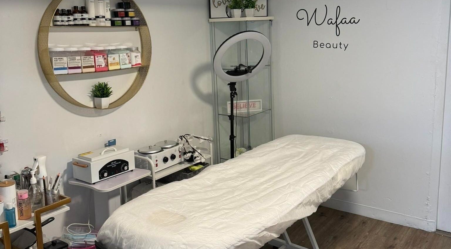 Beauty treatment room at Wafaabeaty in New York, New York, US, featuring a neatly arranged bed and skincare products.