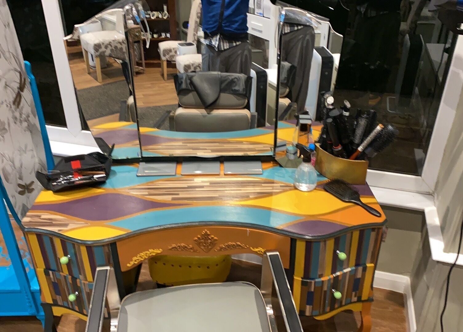 Colorful styling station at Hot Heads Hair Design, Portishead, North Somerset, GB with brushes and mirrors.