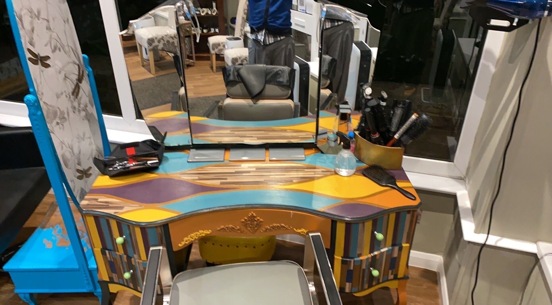 Colorful styling station at Hot Heads Hair Design, Portishead, North Somerset, GB with brushes and mirrors.