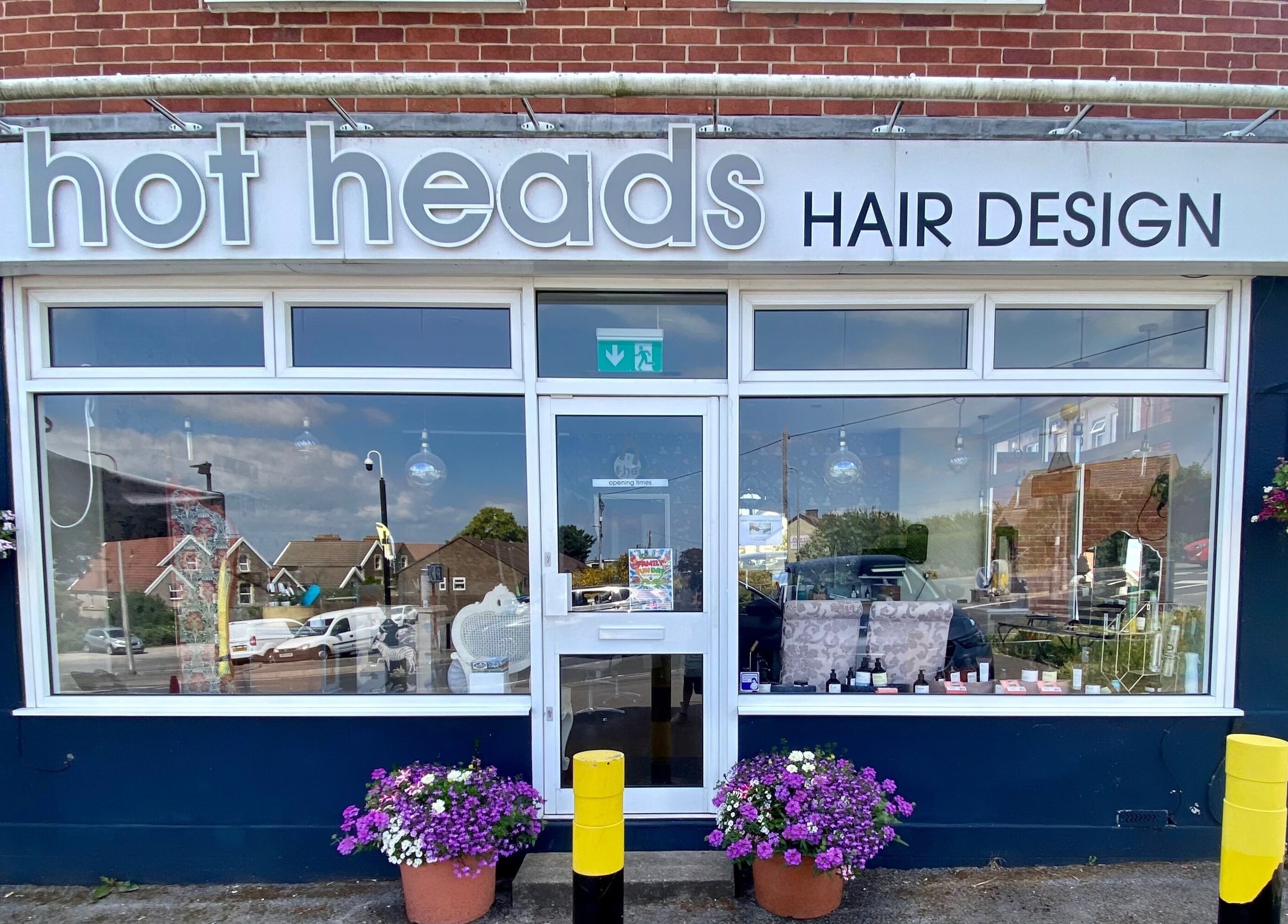 Hot Heads Hair Design exterior in Portishead, North Somerset, GB, with floral decorations and modern signage.
