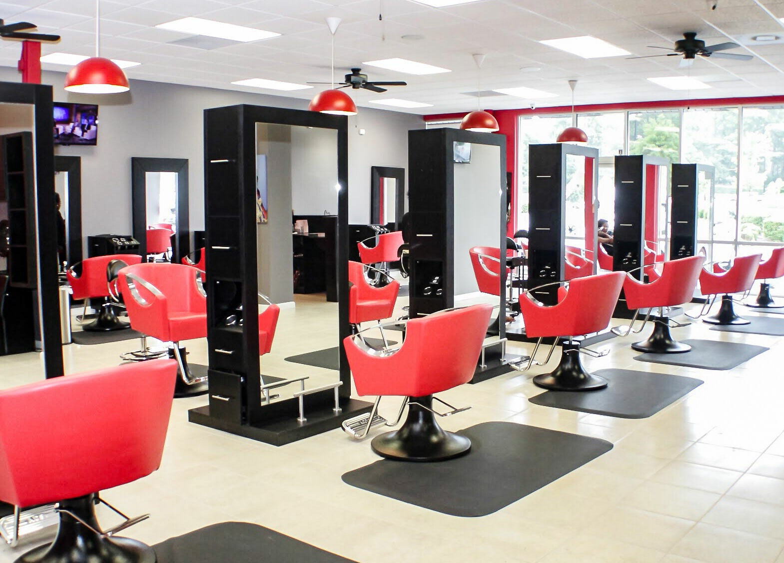 Modern salon with vibrant red chairs at Bignons on South Tryon, Charlotte, North Carolina, US.