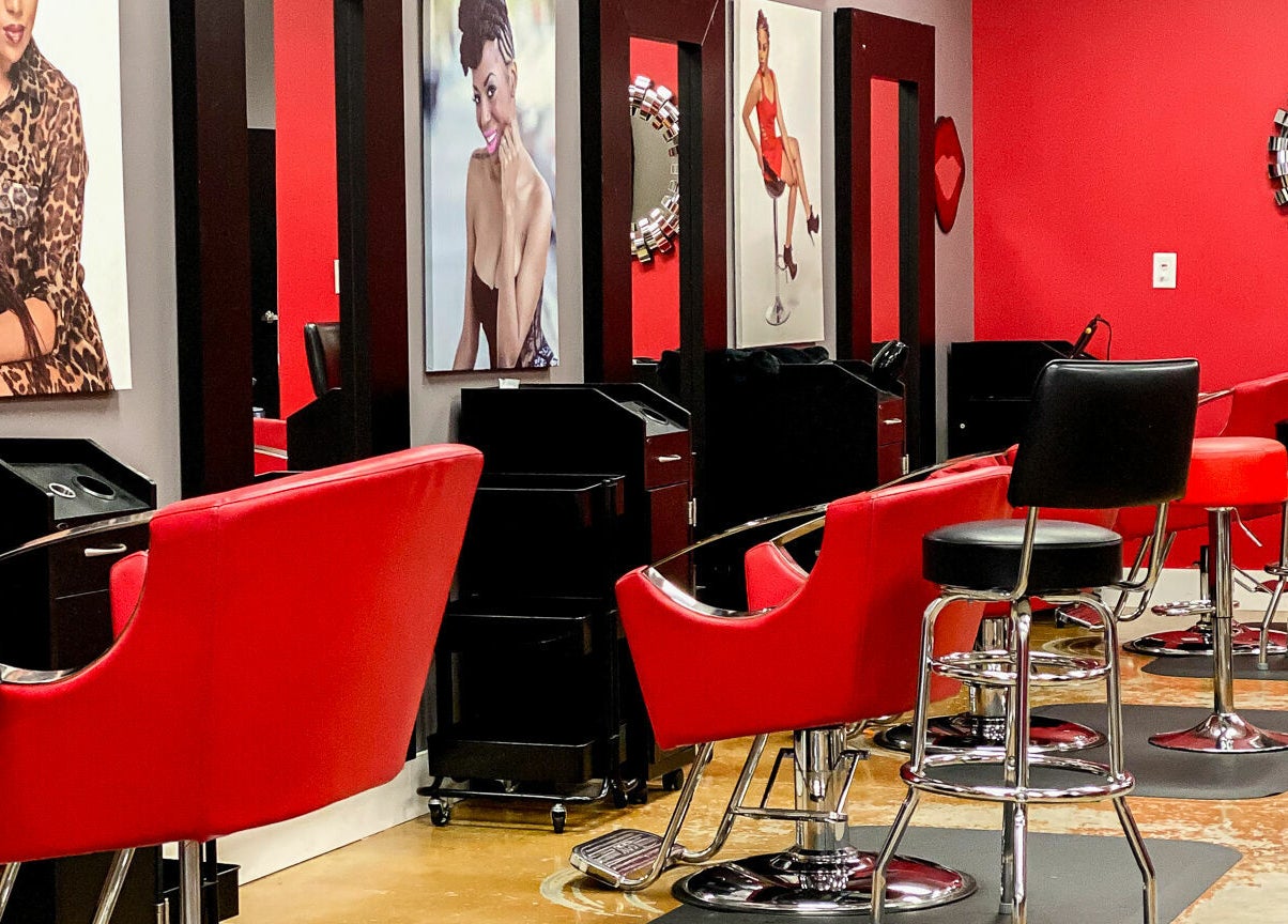 Modern salon with vibrant red chairs at Bignons at South Tryon, Charlotte, North Carolina, US.