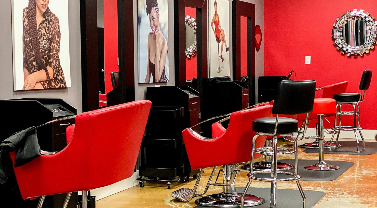 Modern salon with vibrant red chairs at Bignons at South Tryon, Charlotte, North Carolina, US.