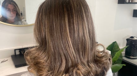 Back view of styled brown hair at Bymolliefay, Runcorn, England, GB salon showcasing glossy curls.