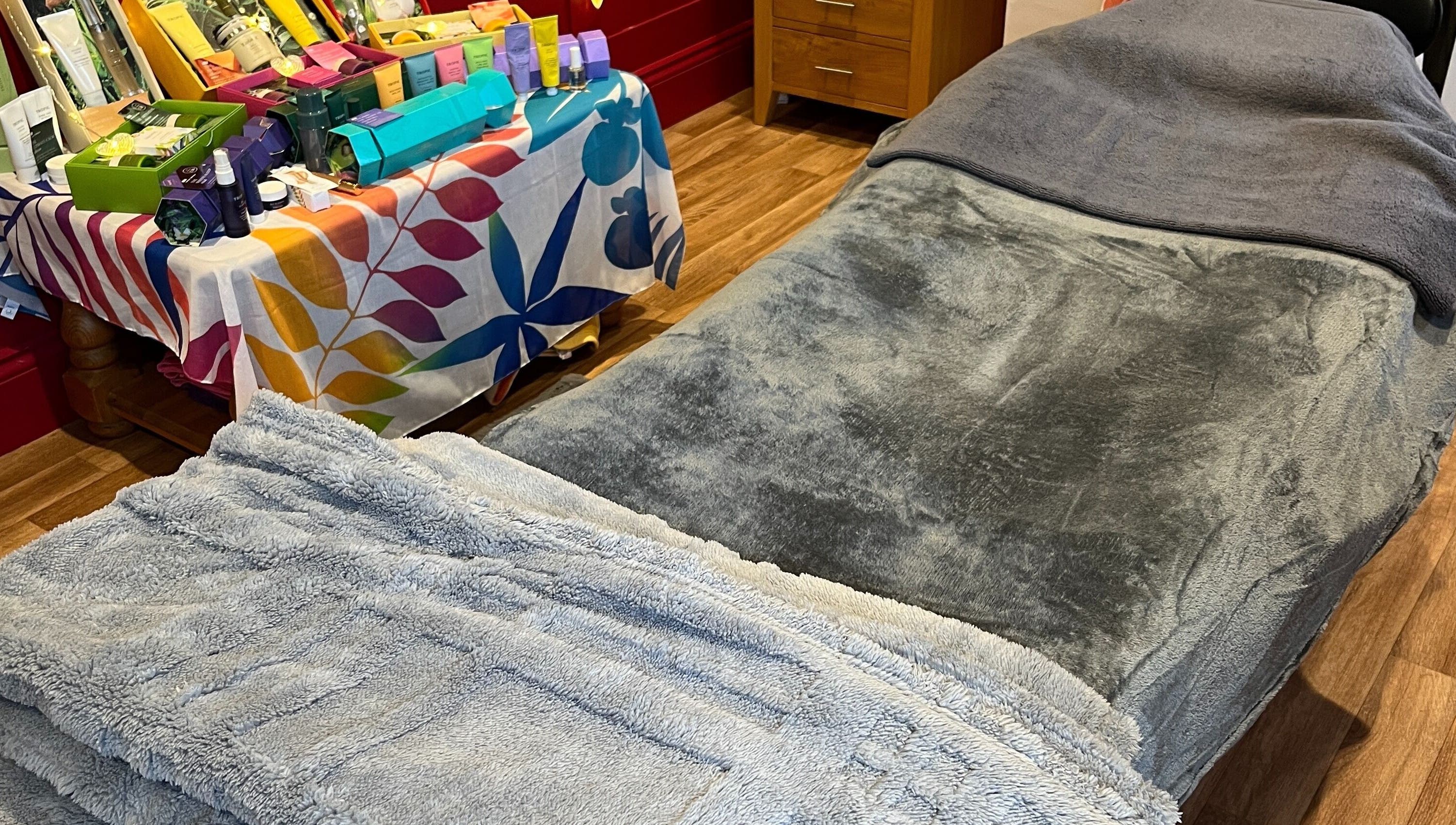 Relaxing treatment room at Sunshine and Daisies, Gillingham, England, GB, showcasing a plush massage table.