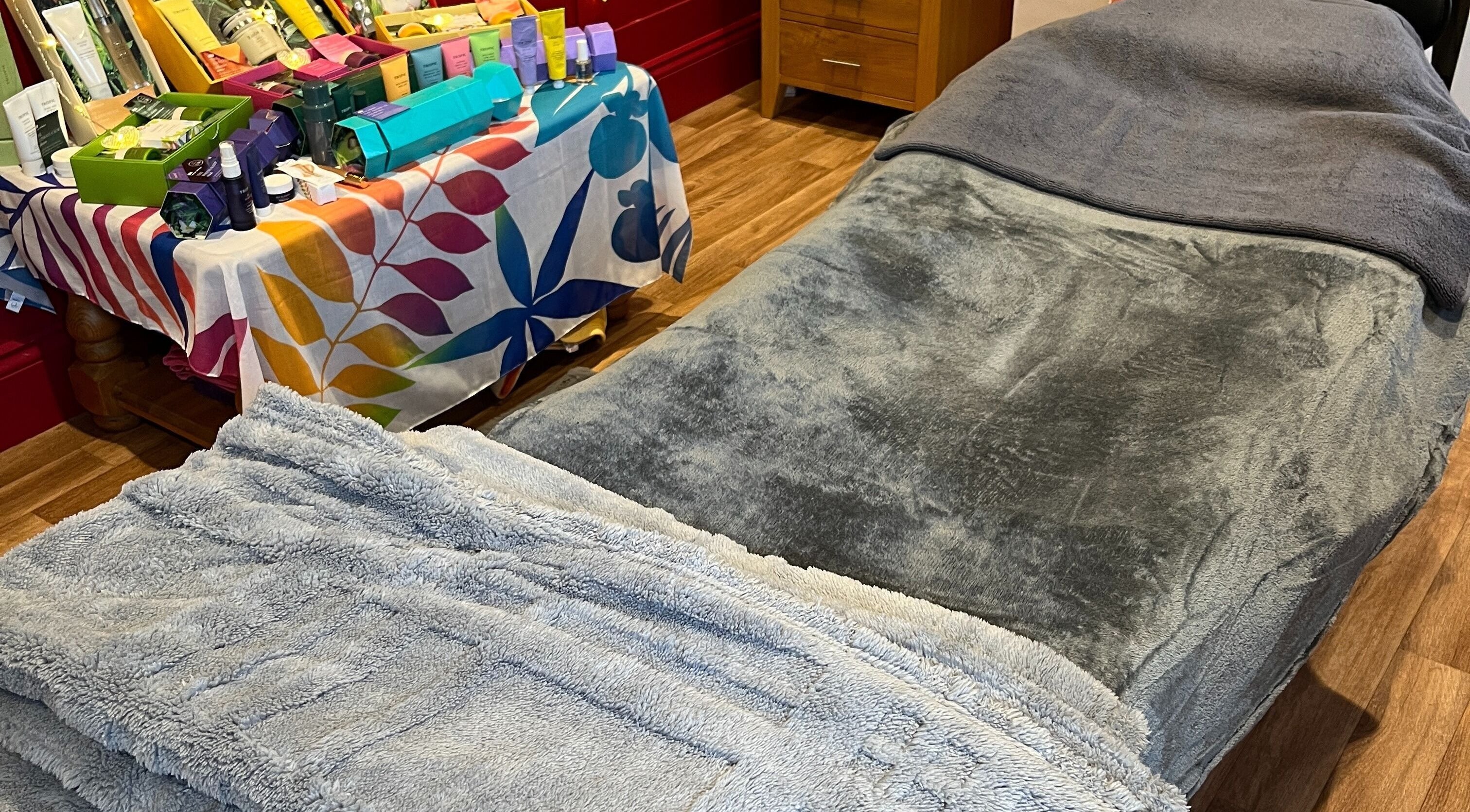 Relaxing treatment room at Sunshine and Daisies, Gillingham, England, GB, showcasing a plush massage table.