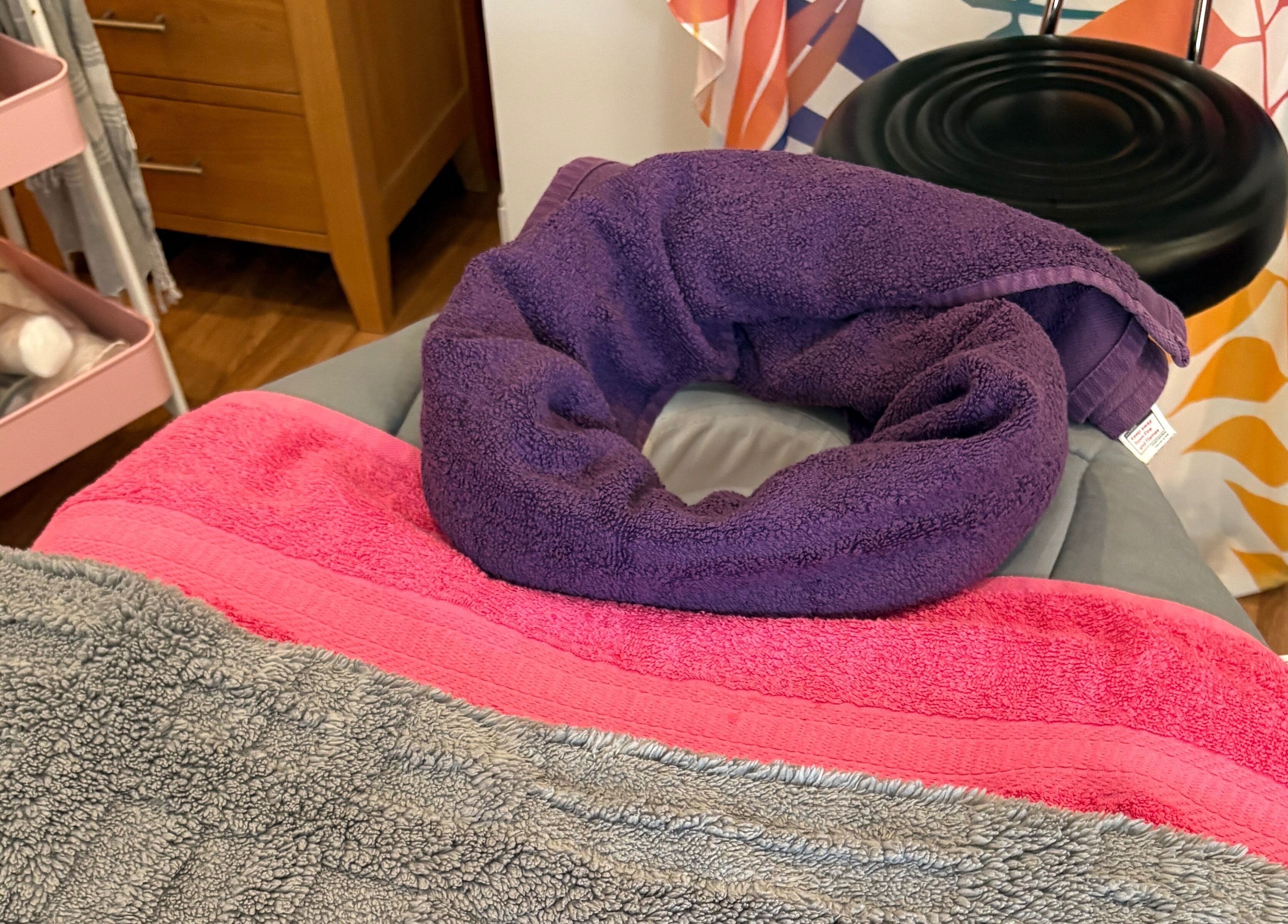 Massage table with colorful towels at Sunshine and Daisies, Gillingham, England, GB.