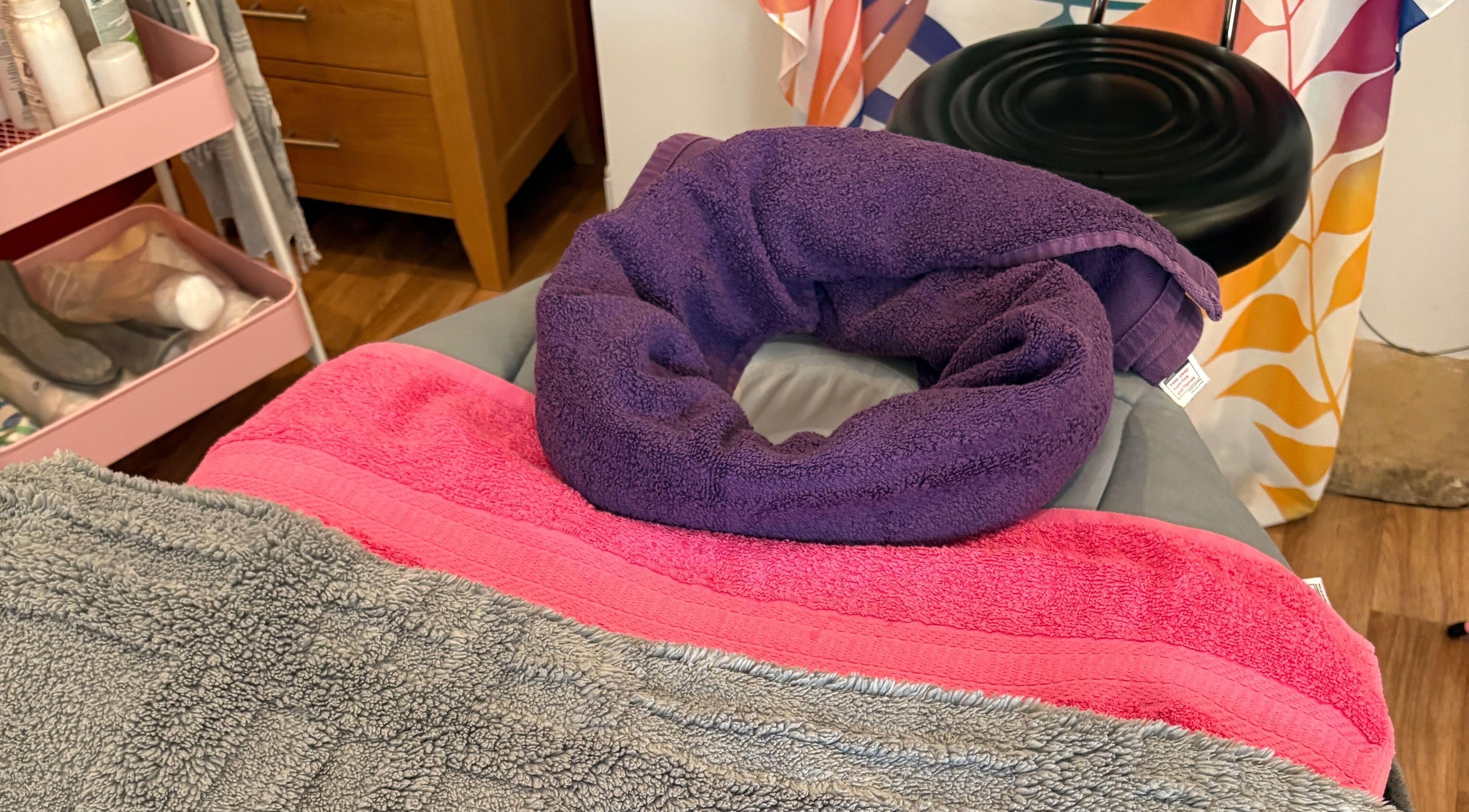 Massage table with colorful towels at Sunshine and Daisies, Gillingham, England, GB.