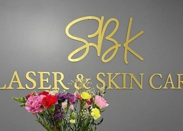 SBK Laser And Skin Care sign with flowers at Toronto, Ontario, CA.