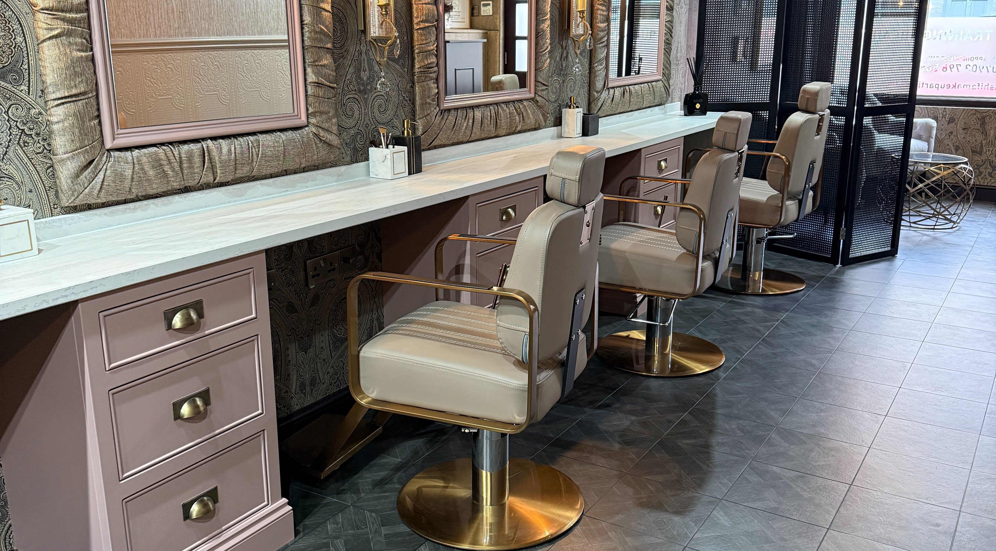 Chic salon interior at Ashifa Make Up and Beauty, Leicester, England, GB, featuring plush styling chairs and mirrors.
