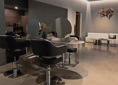 Modern salon interior at Urban New Concept, Christchurch, Canterbury, NZ with stylish seating and decor.