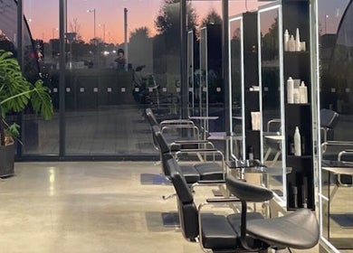 Modern salon seating at Urban New Concept, Christchurch, Canterbury, NZ against a sunset backdrop.