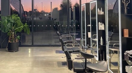 Modern salon seating at Urban New Concept, Christchurch, Canterbury, NZ against a sunset backdrop.