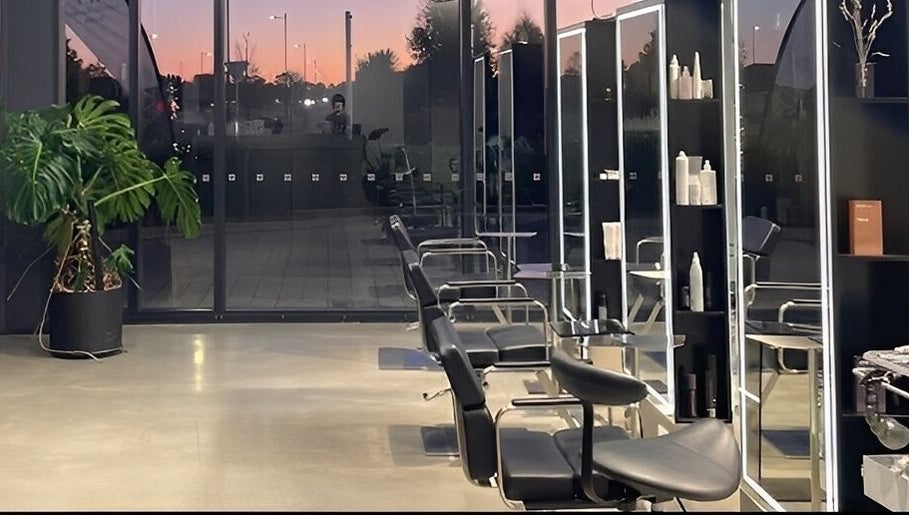 Modern salon interior at Urban New Concept, Christchurch, Canterbury, NZ, showcasing sleek styling stations.