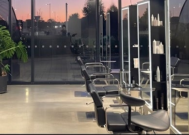Modern salon interior at Urban New Concept, Christchurch, Canterbury, NZ, showcasing sleek styling stations.