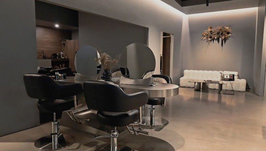 Modern salon interior at Urban New Concept, Christchurch, Canterbury, NZ, featuring sleek styling stations.