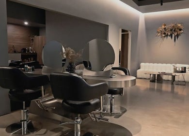 Modern salon interior at Urban New Concept, Christchurch, Canterbury, NZ, featuring sleek styling stations.