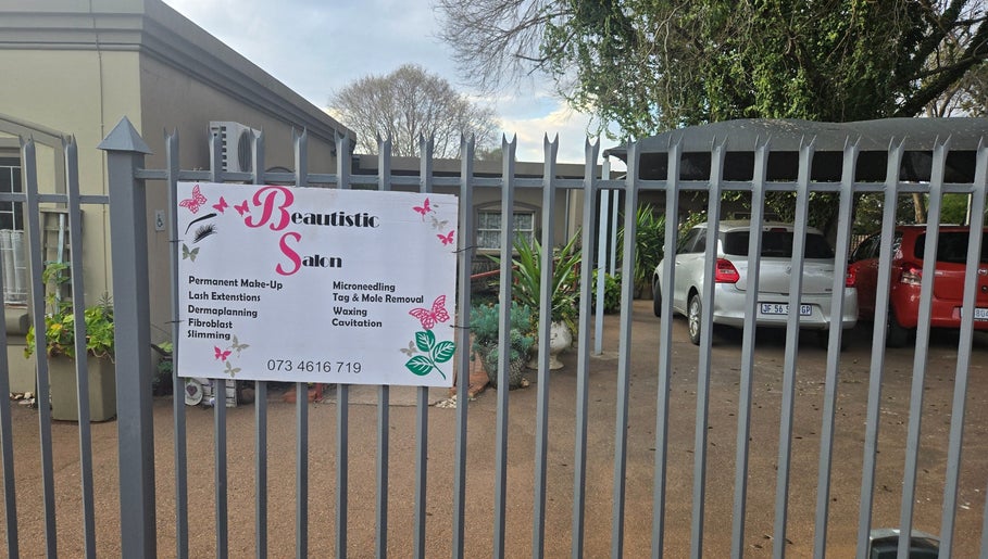 Entrance gate to Beautistic Salon in Pretoria, Gauteng, ZA showcasing salon services and contact info.