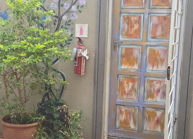 Vibrant entrance to Beautistic Salon, Pretoria, Gauteng, ZA, with artistic door and potted plants.