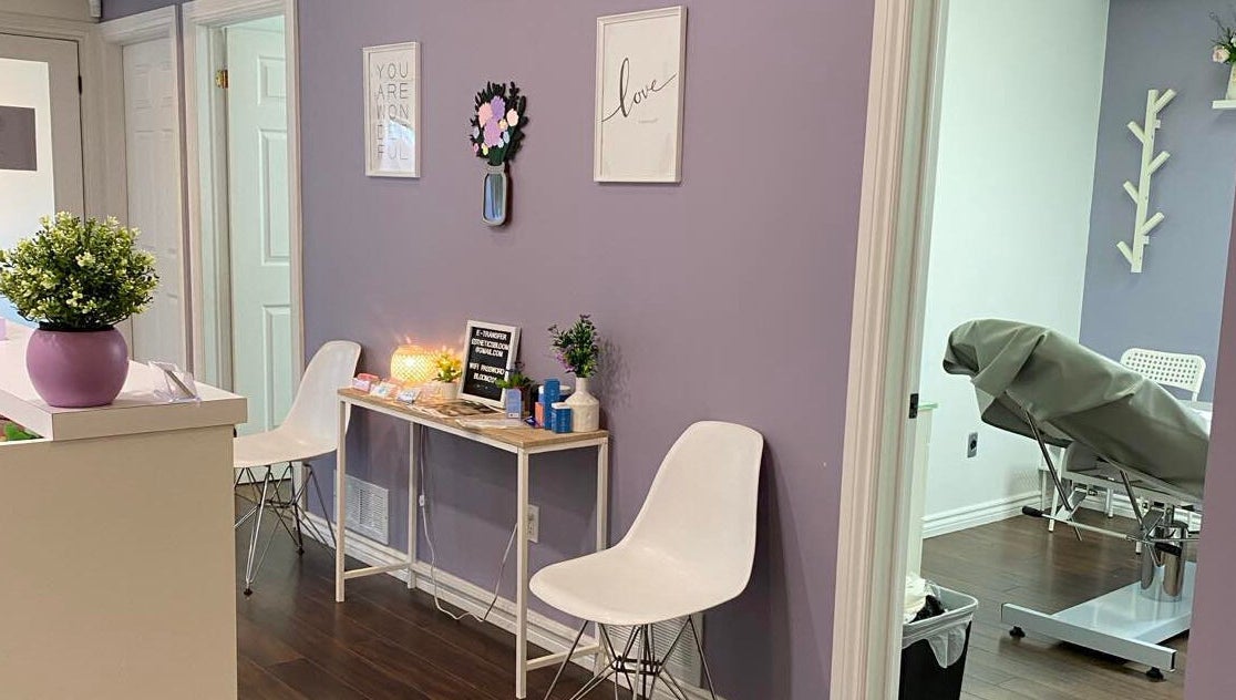 Reception area of Bloom Aesthetics in Cambridge, Ontario, CA with calming decor and seating.
