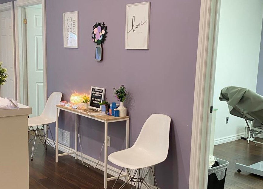 Reception area of Bloom Aesthetics in Cambridge, Ontario, CA with calming decor and seating.