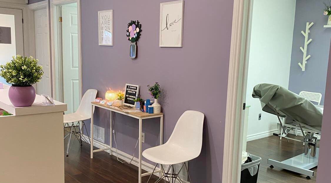 Reception area of Bloom Aesthetics in Cambridge, Ontario, CA with calming decor and seating.