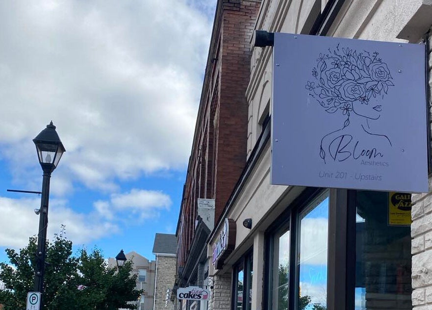 Bloom Aesthetics sign located at Cambridge, Ontario, CA, displayed on a quaint urban street.