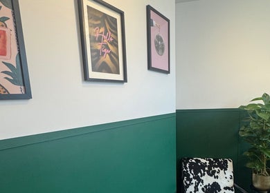 Modern decor in Sophie Knight Studio, Hereford, England; featuring framed art and vibrant green wall.