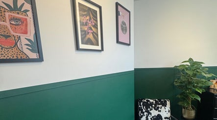 Modern decor in Sophie Knight Studio, Hereford, England; featuring framed art and vibrant green wall.